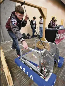  ?? PHOTOS BY TERRY HAGERTY / FOR THE BASTROP ADVERTISER ?? Bastrop High School student Nathan Petrie works with a robot.