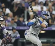  ?? THE DODGERS’ David Zalubowski Associated Press ?? Eddy Alvarez singles in a run off Rockies pitcher German Marquez in the fourth.