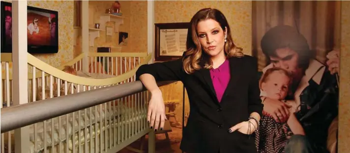  ?? Photo: AP/Lance Murphey, File. ?? Lisa Marie Presley stands next to her childhood crib displayed with other mementos in the exhibit “Elvis Through His Daughter’s Eyes,” at Graceland in Memphis, Tennessee, January 31, 2012.