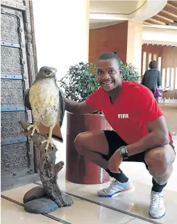  ?? /SUPPLIED ?? Siwela poses next to a falcon, the United Arab Emirates’ national bird, during the Fifa referees seminar in Dubai a fortnight ago.