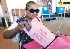  ?? AP ?? Top: Voters cast their ballots at the Tuttle Park Recreation Centre polling location on Tuesday.Above: Yolanda Jimenez casts her mail-in ballot in at the voting centre at the California Museum on Monday in Sacramento, California.