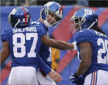  ?? SETH WENIG — THE ASSOCIATED PRESS FILE ?? New York Giants wide receiver Sterling Shepard (87) celebrates with quarterbac­k Eli Manning (10) and running back Paul Perkins (28) after scoring a touchdown against the Chicago Bears in East Rutherford, N.J. on Nov. 20. Manning has started 194...