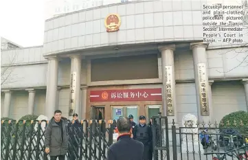  ??  ?? Security personnel and plain-clothed police are pictured outside the Tianjin Second Intermedia­te People’s Court in Tianjin. — AFP photo