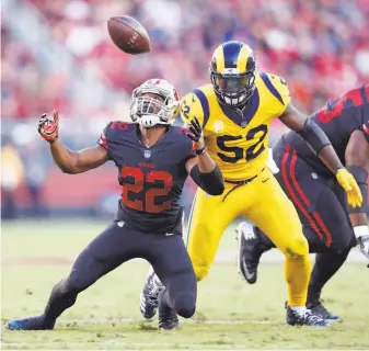  ?? Scott Strazzante / The Chronicle ?? Niners running back Matt Breida bobbles and drops a pass thrown to him in front of Rams linebacker Alec Ogletree during the first quarter of L.A.’s victory.