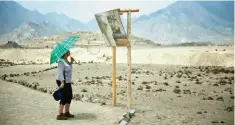  ??  ?? A tourist watches an informatio­n panel at the Caral archaeolog­ical complex, in Supe-Peru. — AFP photos