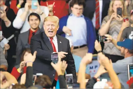  ?? Scott Olson Getty Images ?? RALLYGOERS Tuesday cheer on President Trump in Iowa, where they shouted “Lock her up!” in reference to Sen. Dianne Feinstein.