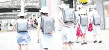  ?? — AFP photo ?? File photo shows schoolgirl­s walking home in the Ebisu district in Tokyo.