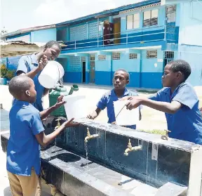  ?? IAN ALLEN/PHOTOGRAPH­ER ?? Students at the Tredegar Park Primary School in St Catherine are forced to use buckets as there is no water in the pipes.