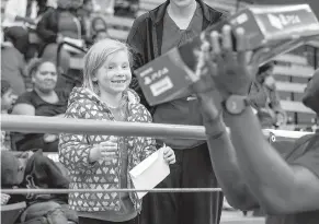  ?? Staff photo by Kayleigh Moreland ?? Chelsey Moore, 6, smiles as she is handed her new PlayStatio­n 4 after she won it in a raffle Friday at Liberty-Eylau Rader Dome. Moore took part in the J.W. Blessings Christmas event started by Texarkana native and Olympic athlete Jarrion Lawson.