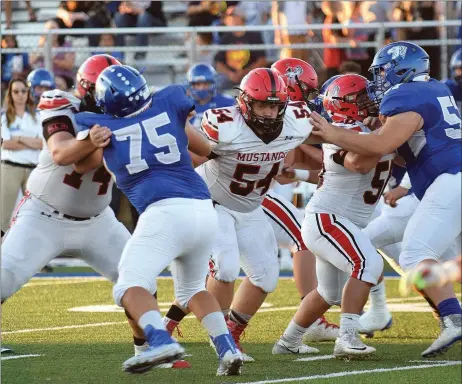  ?? RICK PECK/SPECIAL TO MCDONALD COUNTY PRESS ?? McDonald County linemen Elliott Wolfe (74), Tanner Harnar (54) and Kaidan Campbell (50), along with Will Gordon and Tryston Leach — not shown, paved the way for Oakley Roessler to run for 287 yards in the Mustangs’ 35-28 loss to Hollister on Sept. 14 at Hollister High School.