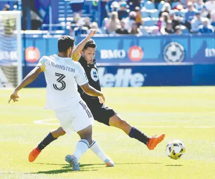  ?? ERIC BOLTE/USA TODAY SPORTS ?? CF Montréal's Joaquin Torres, in black, plays the ball while Chicago Fire FC'S Jonathan Rey Bornstein defends Sunday at Stade Saputo. CFM rode a second-half goal by Romell Quioto for 20 minutes, then benefitted from a late own-goal in a 2-0 win.