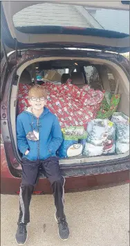  ?? COURTESY PHOTO ?? Jaxton Jowers of Farmington sits in front of Christmas presents he is delivering to the residents at Peachtree Village in Farmington. Jaxton raised money for the gifts by making “mask keepers,” a strap made of parachute cord with clips tied to each end. People can then attach their facemasks to each clip so the mask will hang around the neck when it’s not being worn.