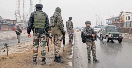  ??  ?? DISPUTED TERRITORY: Indian soldiers stand guard on a road near the site of the explosion in Pampore in Indian-controlled Kashmir