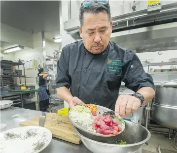  ??  ?? Chef Tom Muromoto of Ka’anapali Beach Hotel in Maui, makes poke, a chopped sushi salad at The Listel Hotel in Vancouver.
