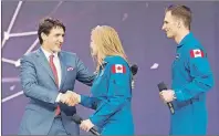  ?? CP PHOTO ?? Prime Minister Justin Trudeau welcomes Canada’s newest astronauts Jennifer Sidey and Joshua Kutryk during Canada 150 celebratio­ns on Parliament Hill in Ottawa on Saturday.