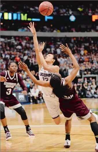  ?? SEAN D. ELLIOT/THE DAY ?? UConn’s Saniya Chong loses the ball trying to put up a shot while driving to the basket against Mississipp­i State’s Dominique Dillingham in the closing seconds of overtime during Friday night’s national semifinal at American Airlines Center in Dallas....