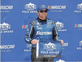  ?? MATTHEW OHAREN/USA TODAY SPORTS ?? Chris Buescher stands with the Busch Light Pole Award after winning the pole on Saturday for the DURAMAX Drydene 400.