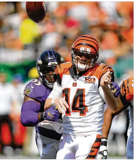  ?? JOHN GRIESHOP / GETTY IMAGES ?? Terrell Suggs of the Ravens knocks the ball from Andy Dalton’s hand in the third quarter of the Bengals’ home loss. Dalton’s day included four intercepti­ons. For the Bengals, the game was “disappoint­ing as it could be,” said coach Marvin Lewis.
