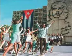  ?? AFP ?? Cuban children dance during a remembranc­e act marking the 31st anniversar­y of the death of revolution­ary Ernesto ‘Che’ Guevara on October 8, 1998, in Havana.