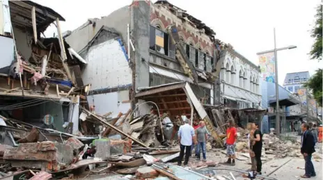  ?? FAIRFAX MEDIA FILE PHOTO ?? Survivors stand amid the chaos of City Mall on Feb. 22, 2011. City Mall was one of the worst-hit parts of Christchur­ch in the quake that killed 185 people.