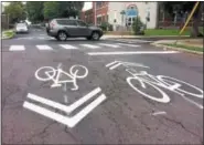  ?? EVAN BRANDT — DIGITAL FIRST MEDIA ?? When roads are too narrow to accommodat­e bike lanes, pavement markers called “sharrows” indicate that bikes and motor vehicles must share the road.