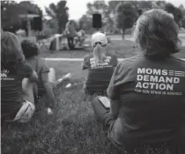  ?? ADAM CAIRNS/ COLUMBUS DISPATCH ?? In response to the death of Olivia Kurtz at Bicentenni­al Park over the weekend, members of Moms Demand Action attend a community rally held by Mothers of Murdered Columbus Children at the site of the shooting on May 24.