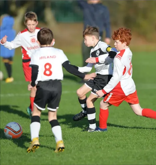  ??  ?? Oisin Reidy of Quay Celtic holds off a challenge from Rock Celtic’s Owen McGahon.