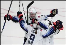  ?? (AP/Chris Carlson) ?? U.S. players celebrate Megan Bozek’s overtime goal against Canada in a Rivalry Series hockey game Saturday in Anaheim, Calif. The United States won 4-3 and won the series.