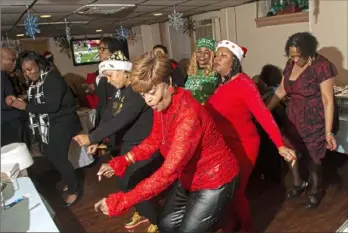  ?? Christian Snyder/Post-Gazette ?? People dance on the second floor of the Wemco Club in Homewood during its annual Christmas party on Dec. 21.