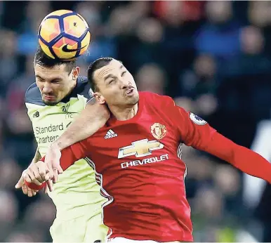  ?? AP ?? Manchester United’s Zlatan Ibrahimovi­c (right) competes for the ball with Liverpool’s Dejan Lovren during the English Premier League match between Manchester United and Liverpool at Old Trafford stadium in Manchester, England, yesterday. The game ended...