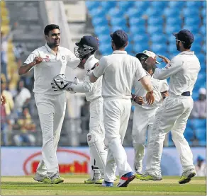  ?? Picture: REUTERS ?? FIVER FEVER: Ravichandr­an Ashwin, left, who took 5/32 yesterday, celebrates with teammates after taking the wicket of Dean Elgar in Nagpur.