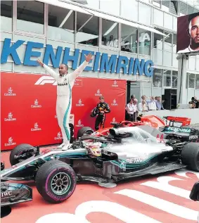  ?? JENS MEYER/THE ASSOCIATED PRESS ?? Lewis Hamilton of Britain celebrates after winning the German Grand Prix Sunday in Hockenheim, Germany.