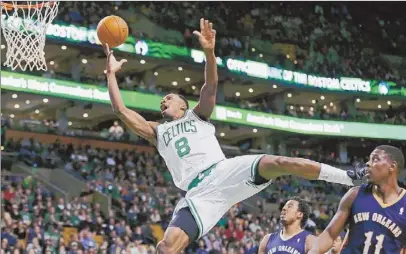  ?? Charles Krupa/Associated Press ?? Celtics forward Jeff Green drives to the basket against Pelicans guard Jrue Holiday (11) and forward Al-Farouq Aminu in the third quarter Friday in Boston.