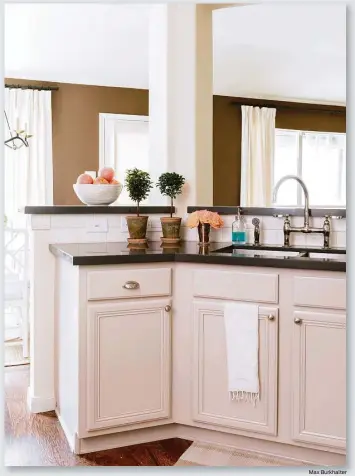  ?? Max Burkhalter ?? Top: Silestone counters in “gray moss” updated the look in the kitchen of interior designer Paloma Contreras. Right: Think of plumbing fixtures, such as this faucet, as the jewelry of your bathroom.