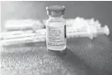  ?? ROGELIO V. SOLIS/AP ?? A vial filled with the Moderna COVID-19 vaccine rests by syringes waiting to be loaded Dec. 7 at a vaccinatio­nstationin­Jackson,Mississipp­i.