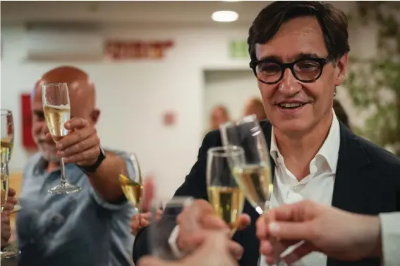  ?? ?? Socialist candidate Salvador Illa makes a toast with members of his team and party colleagues after the announceme­nt of the results of elections to the Catalan parliament in Barcelona, Sunday May 12, 2024. The Socialists led by former health minister Illa won a majority of 42 seats, up from their 33 seats in 2021 when they also barely won the most votes but were unable to form a government. They will still need to earn the backing of other parties to put Illa in charge.(AP Photo/Emilio Morenatti)