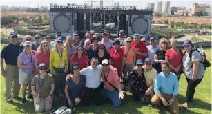  ?? (JNF.org) ?? BEERSHEBA MAYOR Ruvik Danilovich (front, center) puts his arms around two of the JNF-USA donors at the River Park and amphitheat­er the organizati­on funded.