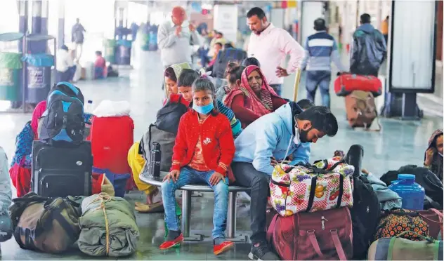  ?? Associated Press ?? ↑
Travellers wait for a train at a railway station in Jammu on Friday.
