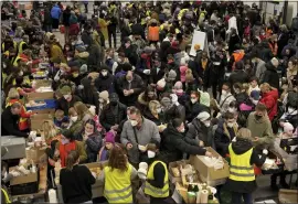  ?? MICHAEL SOHN — THE ASSOCIATED PRESS ?? Ukrainian refugees line up for food in the welcome area after their arrival at the main train station in Berlin, Germany, earlier this month.