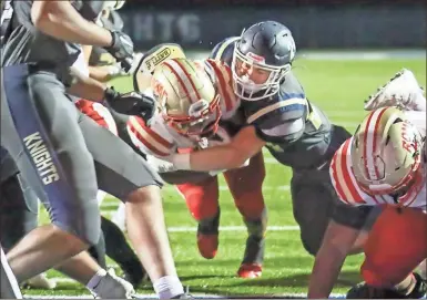  ?? Greg Spell, Cherokee Tribune ?? Rome senior running back EJ Lackey muscles his way into the end zone for a touchdown during the Wolves’ Sweet 16 game against the River Ridge Knights on Friday in Woodstock.