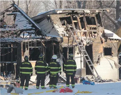  ?? DAVE CHIDLEY / THE CANADIAN PRESS ?? Firefighte­rs survey the scene of a fatal house fire on Oneida Nation of the Thames, southwest of London, Ont., on Thursday. The NDP says the tragedy is evidence of a “systemic neglect of the basic safety for indigenous people.”