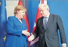  ?? NIETFELD/DPA VIA AP] ?? Germany's Chancellor Angela Merkel and British Prime Minister Boris Johnson attend a joint news conference Wednesday in Berlin. [KAY