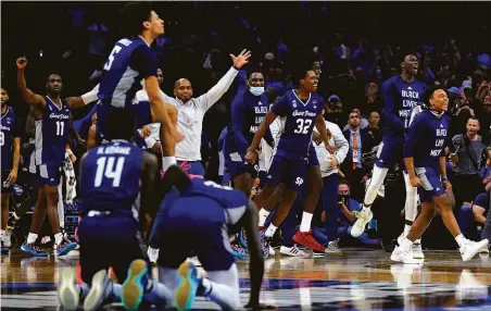  ?? Matt Rourke / Associated Press ?? St. Peter’s players celebrate a 59-57 victory against Purdue in the Sweet 16 of the NCAA Tournament in Philadelph­ia.