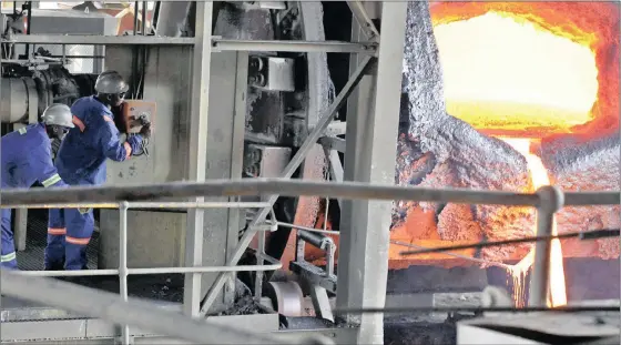  ?? PHOTO: REUTERS ?? Employees work near a platinum smelter at Selous Metallurgi­cal Complex near Harare. Capital constraint­s and spiking costs bedevil almost every one of the mines in the country.