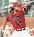  ?? ROB SCHUMACHER/THE REPUBLIC ?? Diamondbac­ks starting pitcher Zac Gallen throws against the Athletics in his spring training debut on Monday at Salt River Fields.