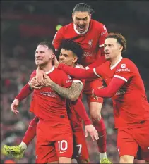  ?? *AP ?? Liverpool’s Alexis Mac Allister (left) is mobbed by teammates after scoring the Reds’ second goal during Thursday’s victory over Sheffield United at Anfield. Mac Allister’s superb strike helped fire Liverpool back to the top of the table with a 3-1 triumph over the basement-dwelling Blades.