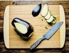  ?? ?? Slice off top and bottom of eggplant. Slice away skin on one side, then the opposite side. Stand eggplant and cut into 8 planks.