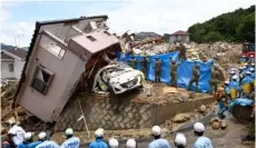  ??  ?? Rescuers conduct a search operation for missing persons in Kumano town, Hiroshima prefecture, western Japan on Monday. SADAyukI GoTo/kyoDo nEwS VIA AP
