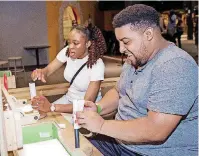  ?? [PHOTO PROVIDED] ?? Two museum guests build paper rockets during SMO 21 in June at Science Museum Oklahoma’s adultsonly night.