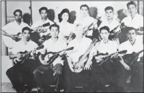  ?? (Courtesy Photo/Hidekazu Tamura) ?? Hidekazu Tamura (second from left in front row) poses with his mandolin band at Gila River War Relocation Center at southeast of Phoenix during the pacific war period. Gila River War Relocation Center was one of 10 internment camps of American Japanese residents during the war.